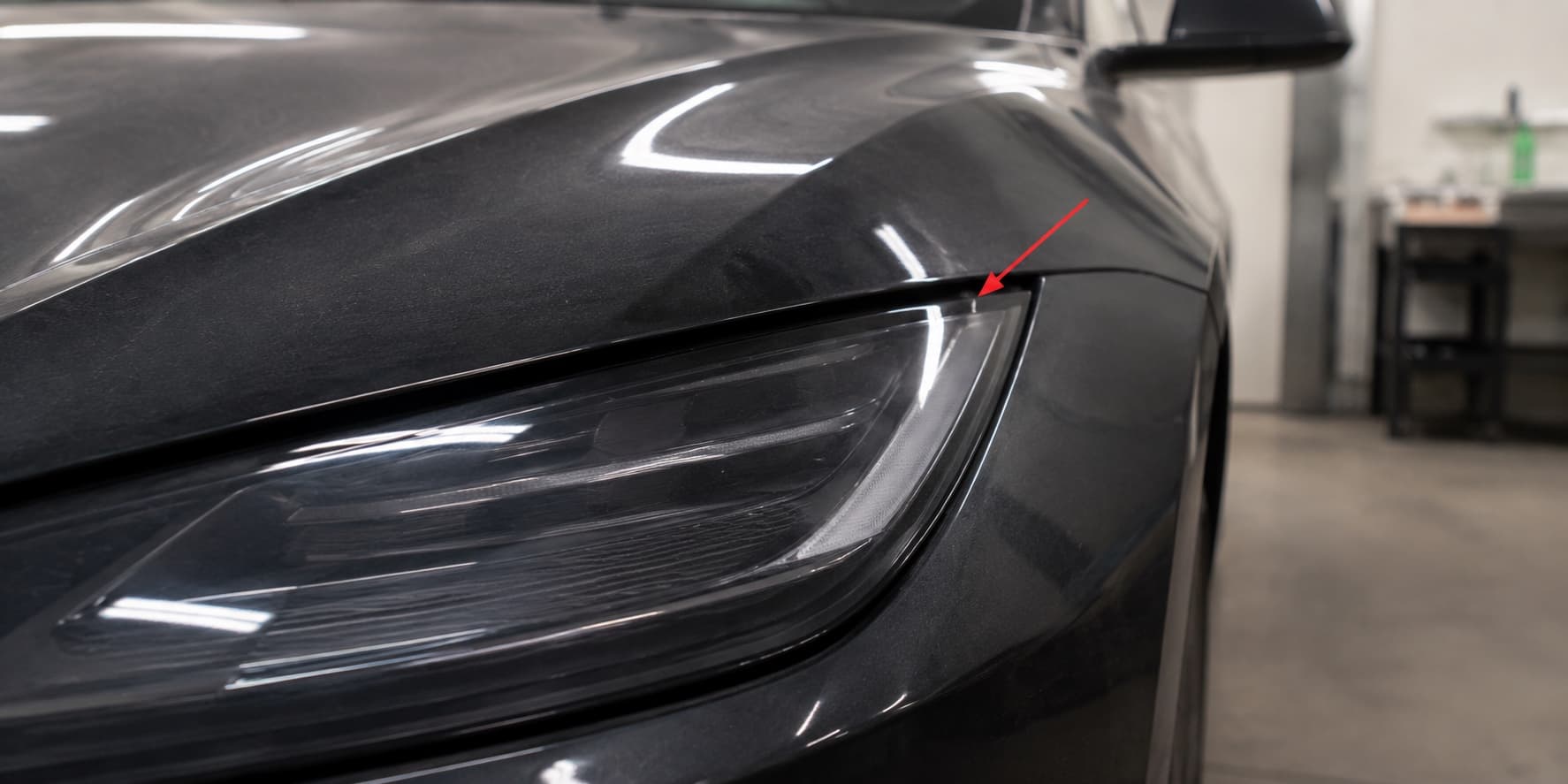 Misaligned Tesla headlight seam, marked with a red arrow