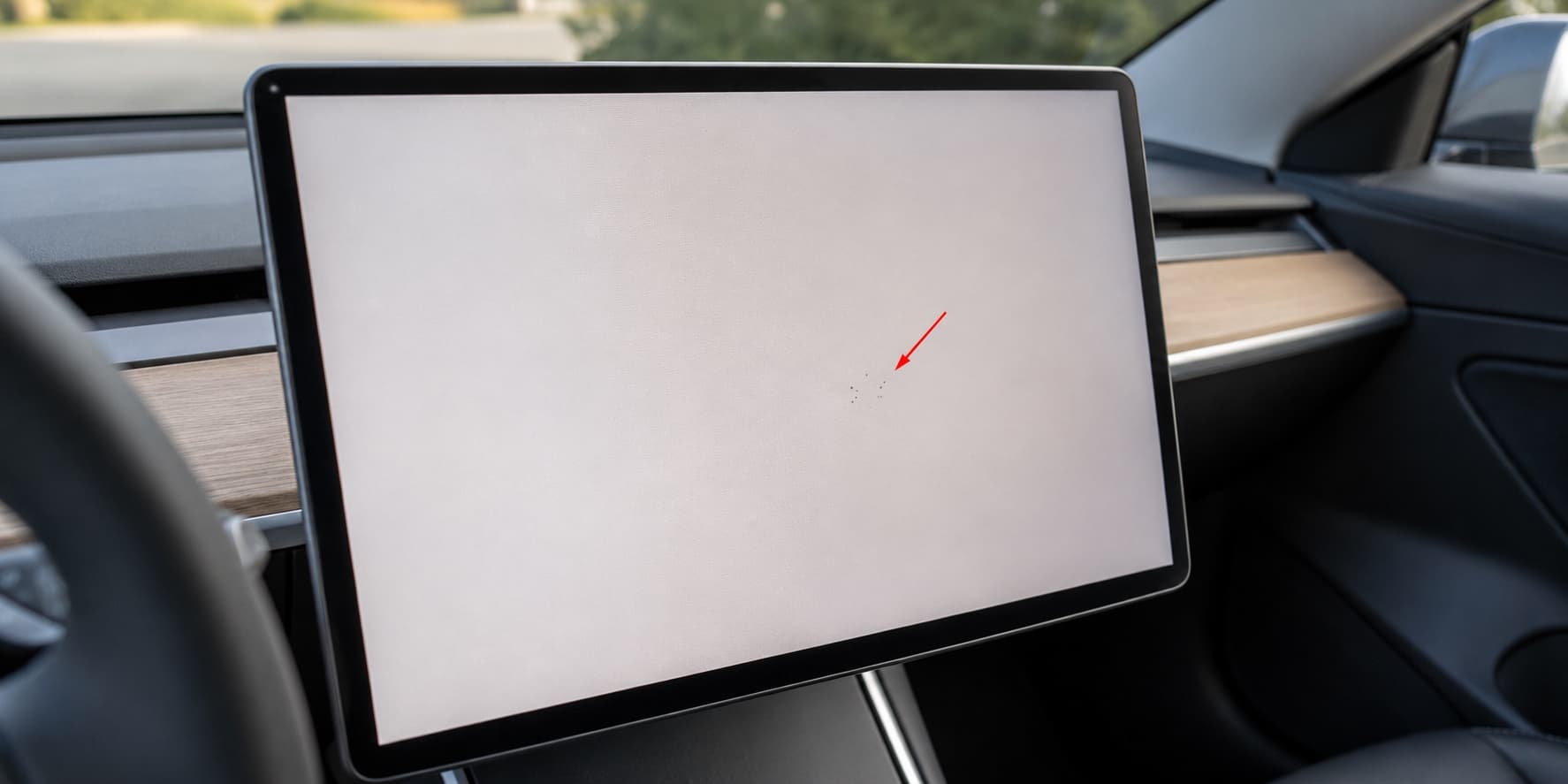 Close-up of a Tesla center touchscreen being checked for dead pixels